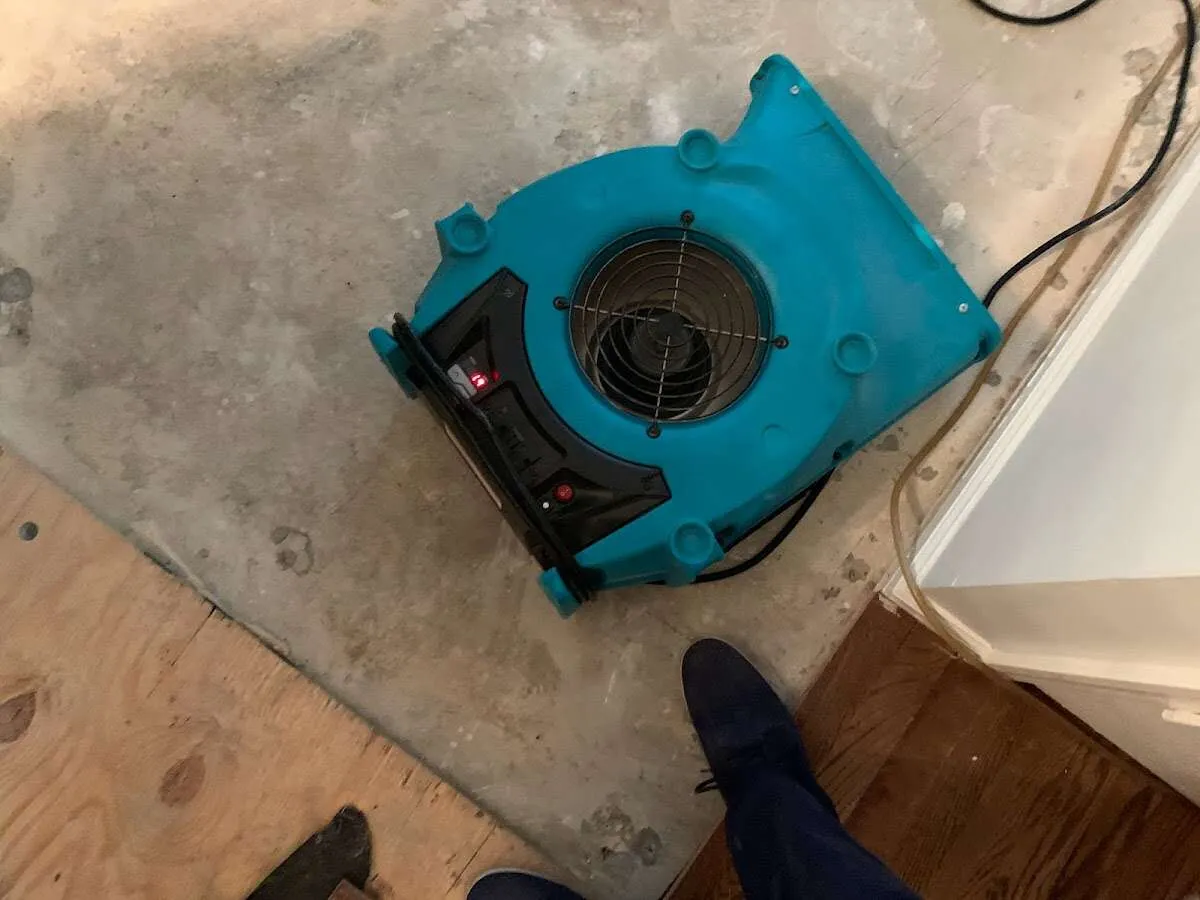 Air mover drying subfloor during Commercial Water Damage Restoration in Seekonk